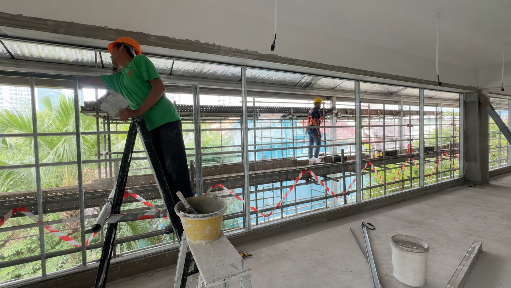 Multi-panel aluminum window wall installation in progress — example related to rain entry diagnosis and continuous drainage